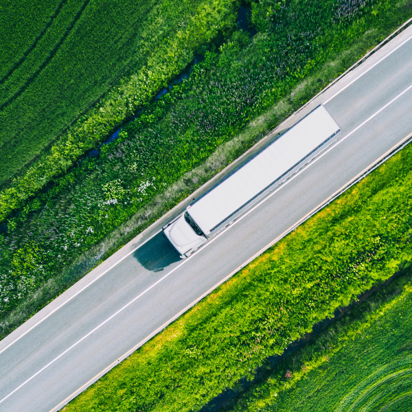 aerial-view-of-a-road-with-a-logistics-truck-driving