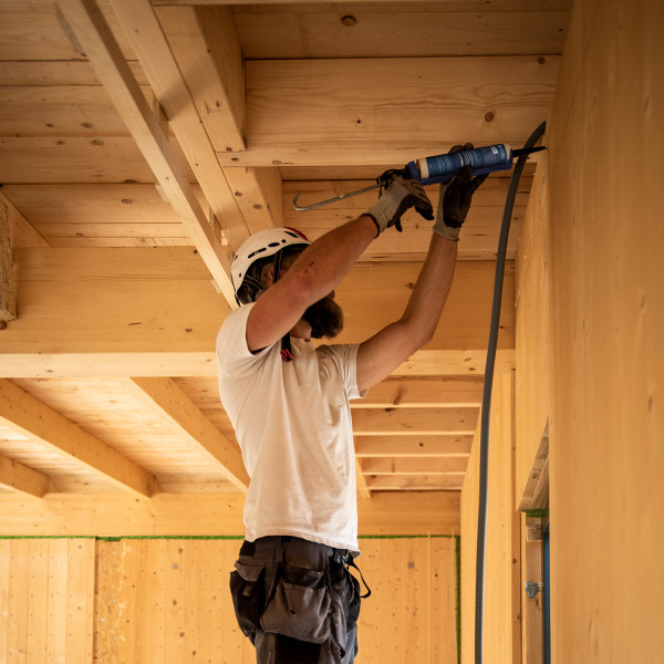 construction worker applying adhesive