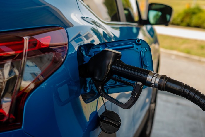 blue-car-refueling-at-gas-station-pump-2026-03-24-13-01-46-utc